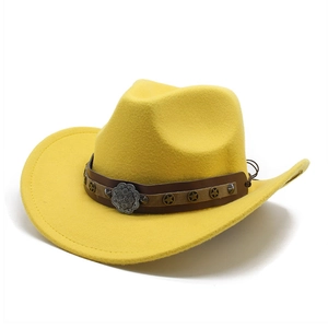 Detail of yellow wool western cowboy hat with brown leather band and star metal studs
