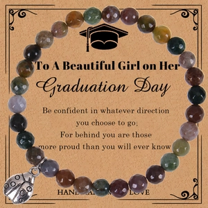 Detail of natural stone bracelet with silver ladybug pendant on graduation gift card