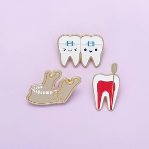 Cartoon dental enamel pins set featuring braces, mandible, and tooth anatomy on purple background