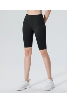 Close-up of high-waisted black yoga shorts with ergonomic seams and tummy control design
