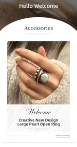 Macro shot of silver open ring with large baroque pearl and layered stackable design