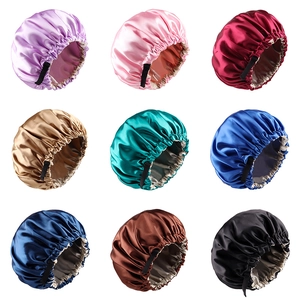 Grid display of nine colorful satin bonnets with adjustable elastic straps on white background