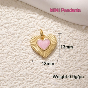 Detailed view of 13mm gold plated heart pendant with pink enamel and 0.9g weight