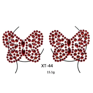 Macro view of butterfly-shaped red crystal body stickers with multifaceted resin gems