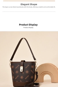 Detail view of printed bucket bag with adjustable leather strap and metal lock closure