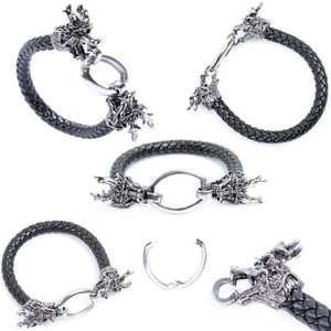 Detail view of woven black leather bracelet featuring a silver metal dragon head clasp