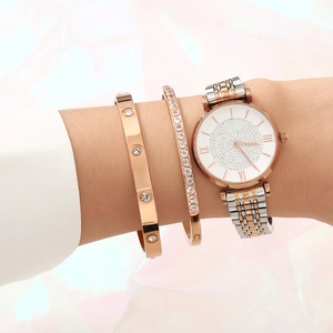 Rose gold watch and zircon studded bangle set worn by model on pink background