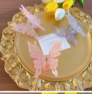 Three-piece set of iridescent butterfly hair claws in pink and purple resin with hollow design