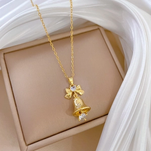 Luxurious gold bow and bell pendant necklace with sparkling cubic zirconia crystals