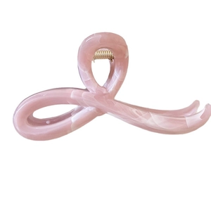 Pink marble texture hair claw clip with vintage bow design and gold spring for women
