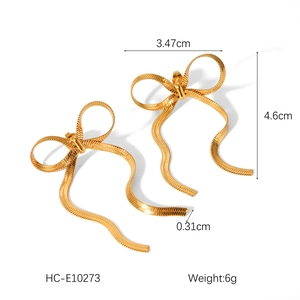 Detailed view of 18k gold stainless steel bow earrings with measurements and snake chain texture