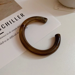 Minimalist open C-shape bracelet in dark brown amber-textured acrylic finish
