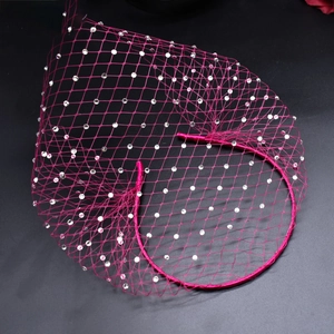 Close-up of fuchsia mesh birdcage veil headband decorated with shiny rhinestones