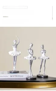 Close-up of ballet dancer figurines set with silver limbs and white layered skirts