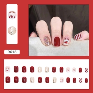 Christmas reindeer press-on nails set in garnet red with glitter and candy cane stripes