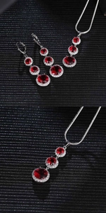 Close-up of teardrop water drop jewelry set with red zircon stones and silver plating