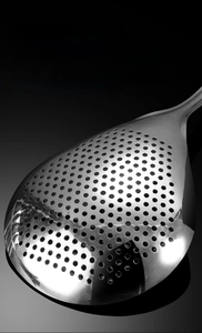 Macro shot of polished 304 stainless steel strainer with uniform fine mesh filter holes