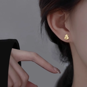 18k gold plated gourd stud earrings with textured matte finish on female model