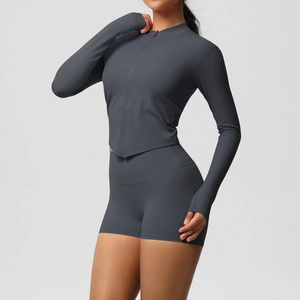 Detailed close-up of dark grey yoga set featuring thumbhole cuffs and a seamless zipper top