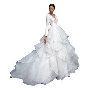 Elegant long sleeve wedding dress with deep V-neck and layered ruffle ball gown skirt
