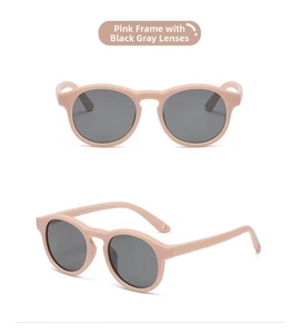 Detail view of pink silicone baby sunglasses showing round frames and polarized lenses