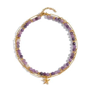 Detail of double-layer necklace with purple faceted beads and gold starfish pendant