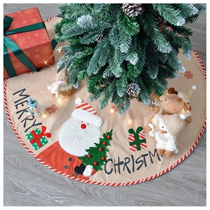 Detailed embroidery of Santa and gift boxes on a large linen Christmas tree skirt decoration