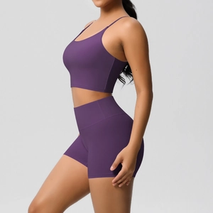 Detail view of deep purple high-waist biker shorts and thin strap sports bra set