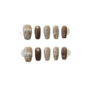 Handmade press-on nails set with tweed patterns, pearls, and autumn brown tones