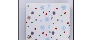Closed white paper gift box featuring festive snowflake heart and star patterns