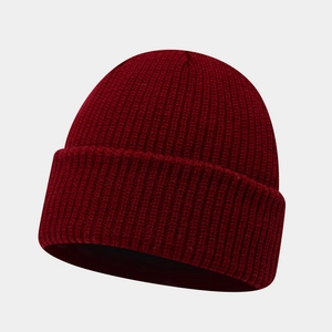 Detailed close-up of dark burgundy rib-knit beanie showing thick textured wool material