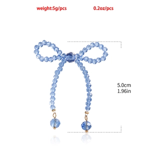 Detailed view of blue beaded bow earrings with long tassels and 5.0cm vertical length