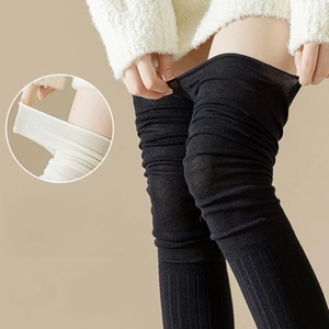 Detail of elastic knitted over-knee thigh high socks in black and white styles