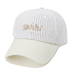 Close-up of striped baseball cap with Shhh embroidery and contrasting beige brim detail