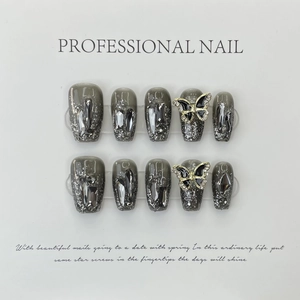 Handmade press-on nails with dark grey glitter, rhinestone accents and butterfly charms