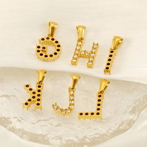 18K gold plated letter pendants with sparkling cubic zirconia on white silk cloth