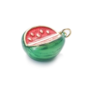 Macro shot of watermelon pendant with red and green enamel coating and metal loop