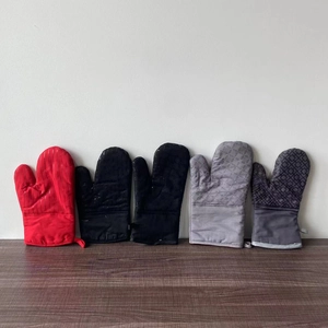 Detailed group view of colorful silicone oven mitts with anti-slip texture on wood surface