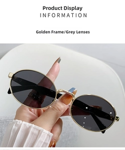 Detail der Vintage-Oval-Sonnenbrille mit Goldmetallrahmen und grauen Gläsern