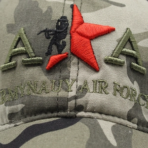 Macro detail of military camouflage cap with embroidered Army Navy Air Force and star