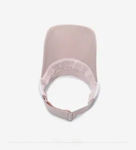 Detail view of pink sun visor interior with sweatband and adjustable buckle