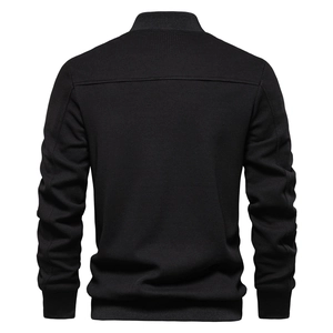 Macro shot of men's black knit jacket showing waffle texture and ribbed stand collar detail