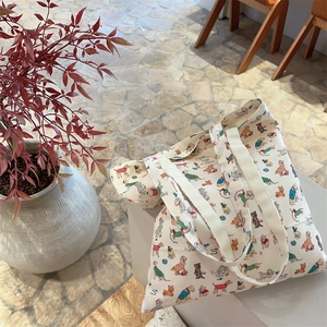 Matching set of cotton canvas tote bag and pouch featuring cute cartoon puppy prints