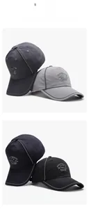 Detail view of four baseball caps featuring reflective piping and embroidered slogans