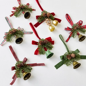 Christmas tree ornaments set with pine cones bows and bells in red green and gold colors