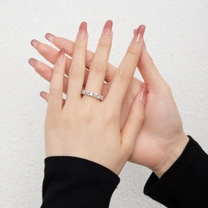 Elegant S925 sterling silver ring with flower zircon inlay on hand over white background