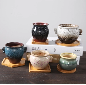 Macro shot of assorted ceramic succulent pots with various glazes and bamboo trays
