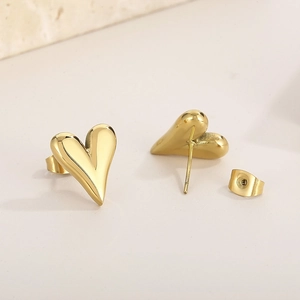 Polished 18K gold-plated heart-shaped stud earrings in stainless steel on beige background