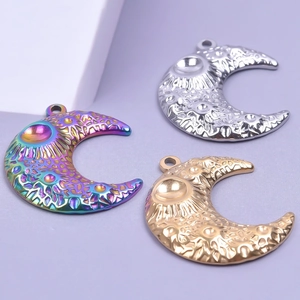 Macro detail of three colorful moon pendants with textured lunar crater surfaces