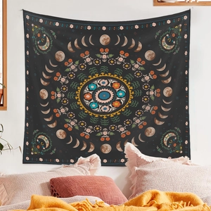 Close-up of Bohemian moon phase and floral mandala tapestry on a bedroom wall